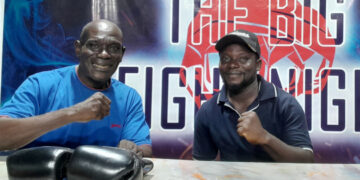 Referee Richard Amevi advises boxers, fans and officials